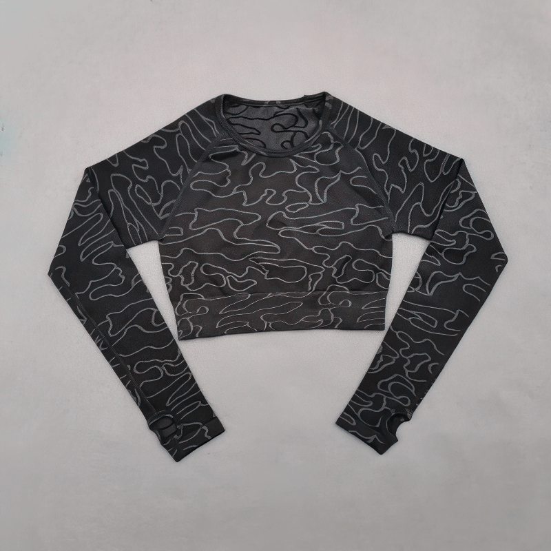 Black seamless long sleeve training crop top for women, ideal for yoga and running, made with breathable nylon and spandex fabric.