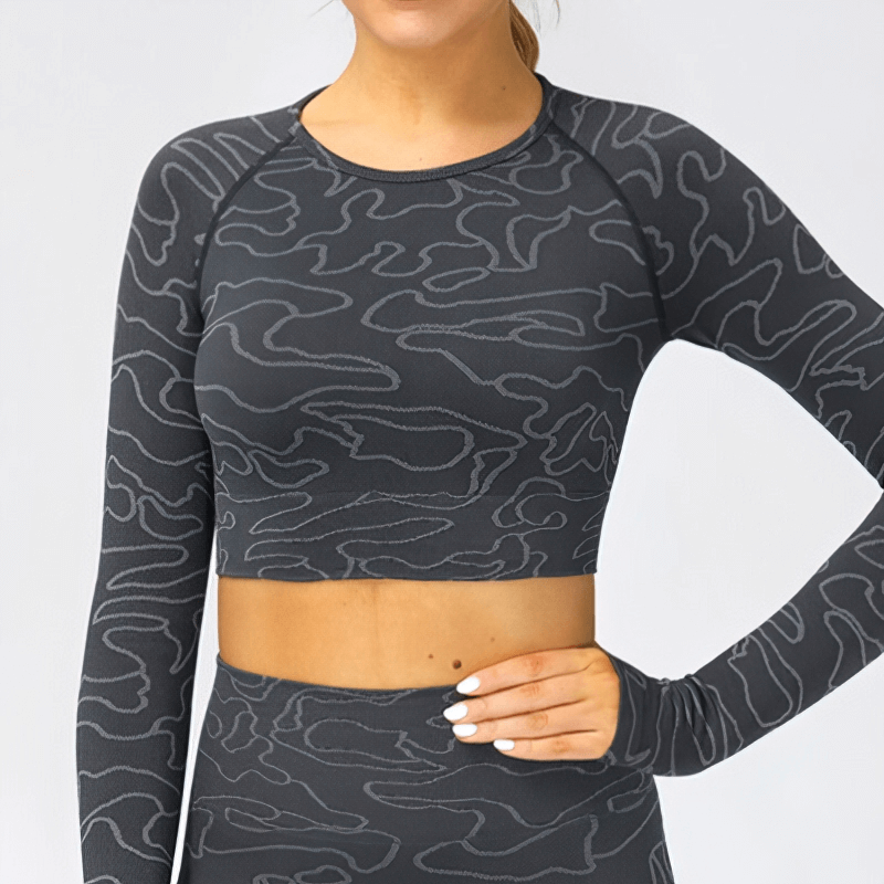 Women's seamless long-sleeve crop top for sports, featuring anti-pilling black broadcloth with breathable nylon and spandex design.