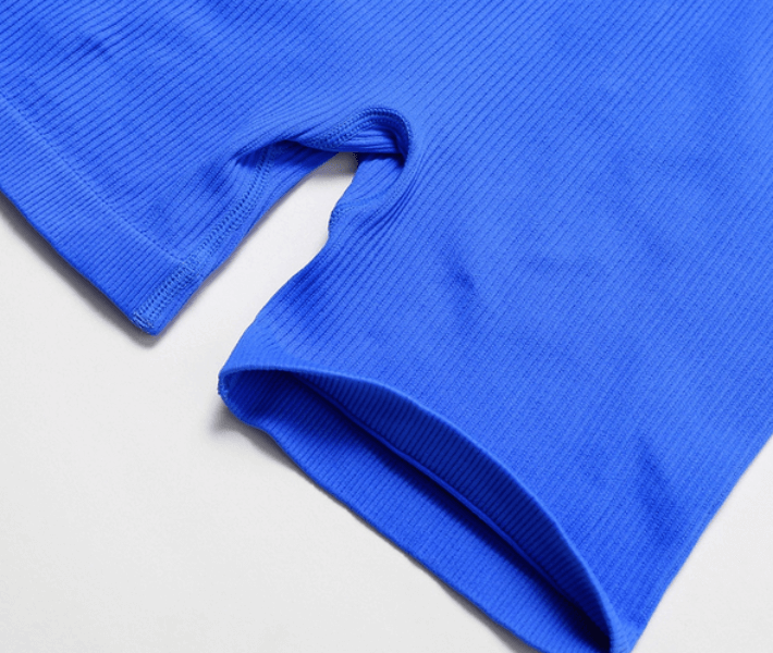 Close-up of seamless royal blue one piece short yoga suit, women's sportswear ideal for yoga and fitness, showing breathable fabric detail.