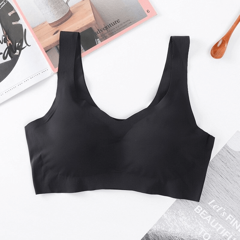 Black seamless women's sports bra, wire-free, made of nylon and spandex, laid flat on a table, perfect for a comfortable workout.
