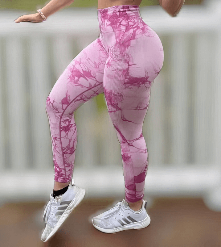 Woman wearing pink seamless tight leggings with push-up effect, showcasing high waist and ankle-length style for confident curves.