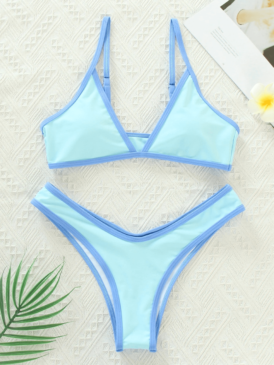 Light blue sexy micro bikini set with adjustable straps on a textured white background.