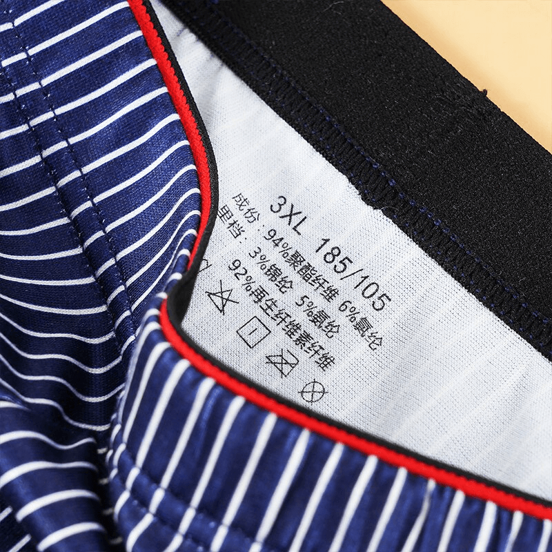Close-up of blue striped men's boxer briefs with elastic waistband, featuring size label 3XL and fabric details.