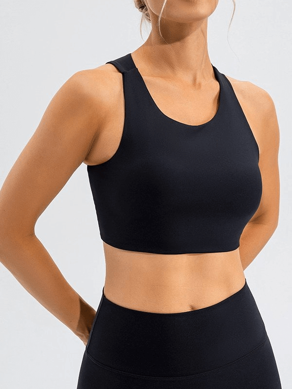 Woman wearing a sexy elastic workout top with open back, showcasing the stylish design and flexibility of the sports bra, ideal for fitness.