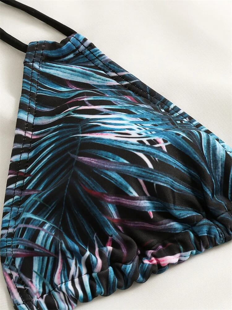 Tropical print bikini top with lush leaf design on women's two-piece swimsuit, low waist. Ideal for beach fashion.