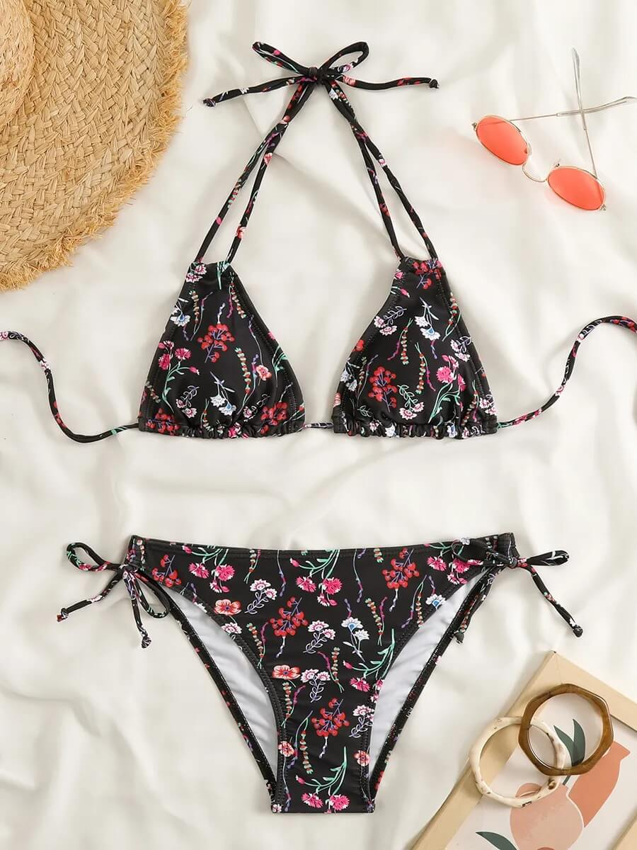 Floral print two-piece bikini set with low waist, perfect for a stylish beach day, featuring a black base and colorful floral patterns.