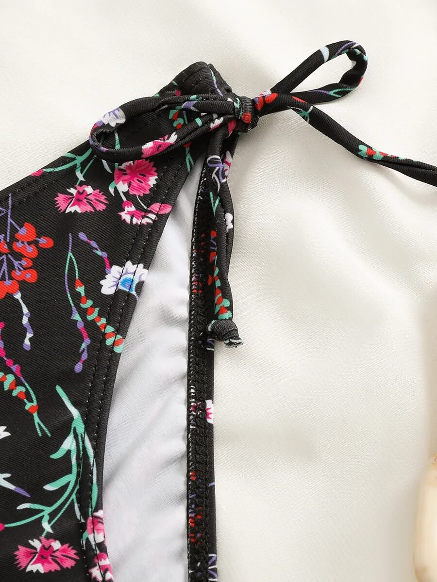 Close-up of floral print detail on black bikini tie from Sexy Ladies Bikinis collection, perfect for a stylish beach look.