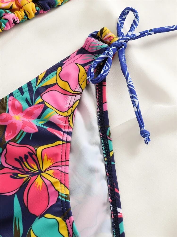Close-up of floral print bikini bottom with adjustable tie, showcasing vibrant colors and stylish design for beachwear.