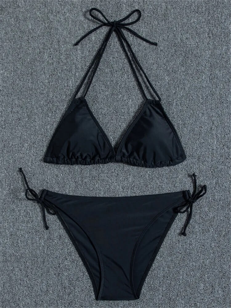 Black two-piece bikini set on grey background, featuring a triangle top and low-waist bottoms, perfect for beachwear.