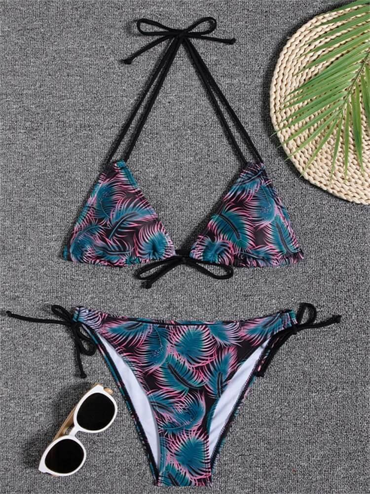Chic printed bikini set with tropical design, paired with stylish sunglasses and palm leaf motif. Ideal for beach fashion enthusiasts.