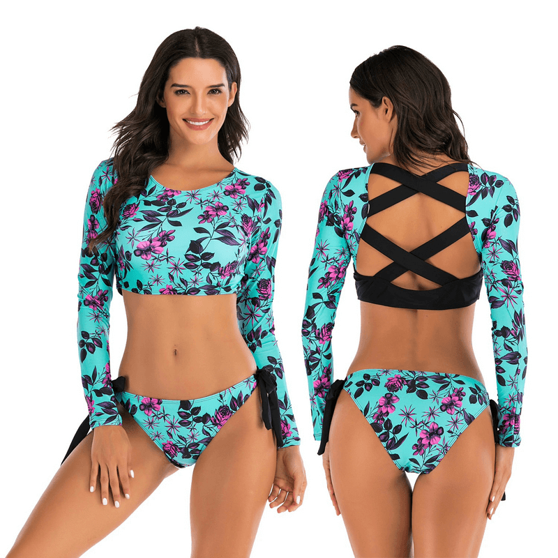 Model wearing sexy long sleeve two-piece swimsuit with floral pattern and backless design, SF0517, in vibrant blue and black.