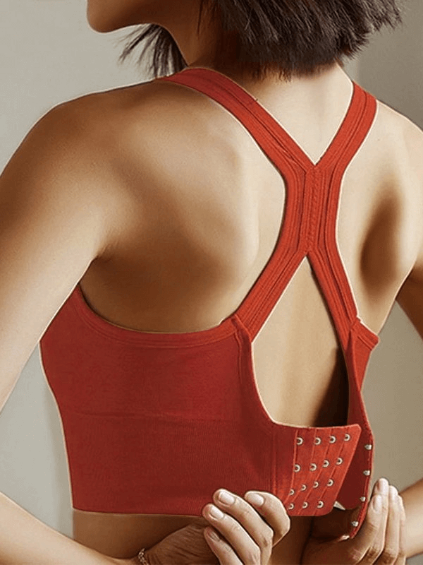 Back view of a red push-up sports bra with back buckle closure, designed for women, ideal for running, made from spandex and lycra.