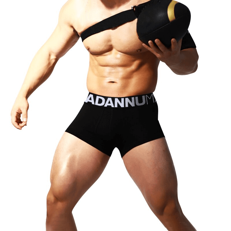 Model in breathable cotton male panties, sports underwear showcasing comfort and performance design with letter pattern.
