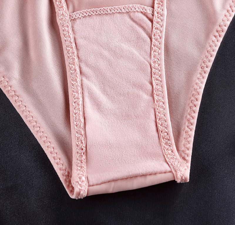Close-up of pink elastic waist panty for women in ice silk fabric, showcasing fine stitching and smooth texture.