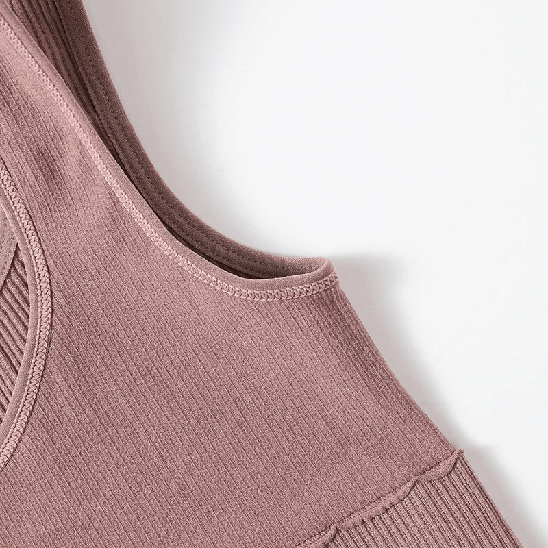 Close-up of a pink ribbed seamless tank top, showcasing breathable fabric and sleek design for women’s fitness activities.