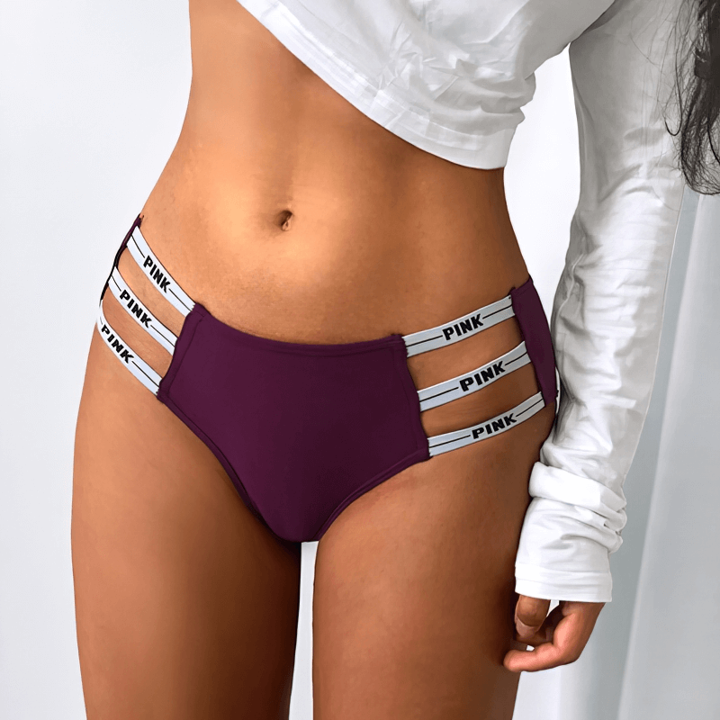 Woman wearing Sexy Sports Women's Briefs with Side Stripes Low Rise, purple color with letter pattern and hollow-out design.