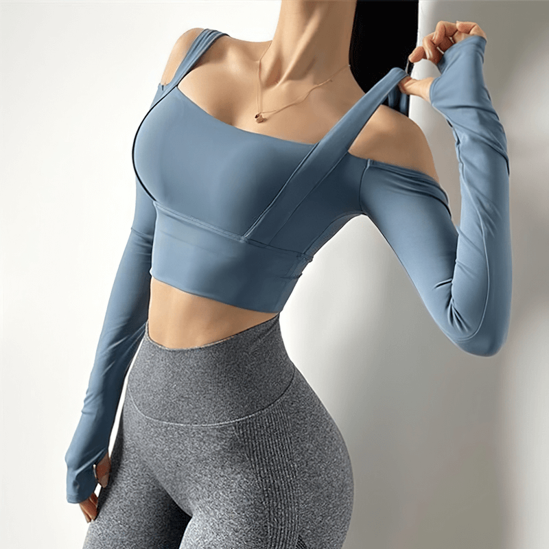 Stylish open-shoulder long sleeve crop top in blue, perfect for gym wear; breathable nylon and spandex fabric; designed for active women.
