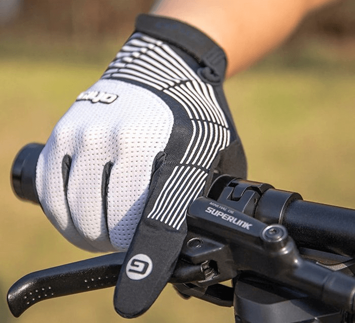 Cyclist wearing windproof gloves with anti-slip grip handle on a bike, promoting secure cycling in windy conditions.
