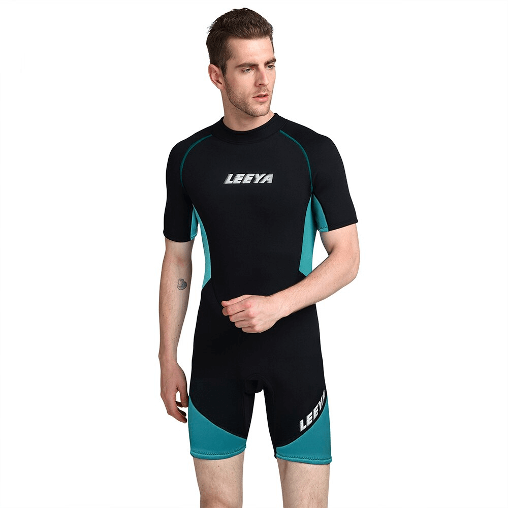 Man wearing short-sleeved sunscreen snorkeling surfing suit, black and teal design, ideal for water sports and sun protection.