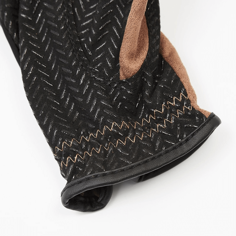 Close-up of black and brown silicone non-slip equestrian glove with Velcro, showing detailed grip pattern for superior control.