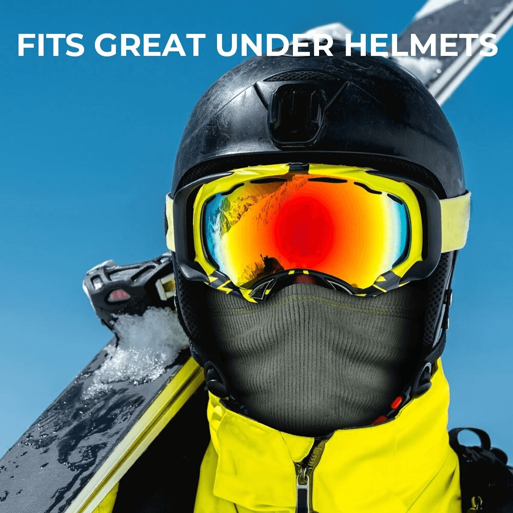Person wearing a helmet and colorful goggles, showcasing a black skiing thermal corduroy elastic scarf on a snowy mountain backdrop.
