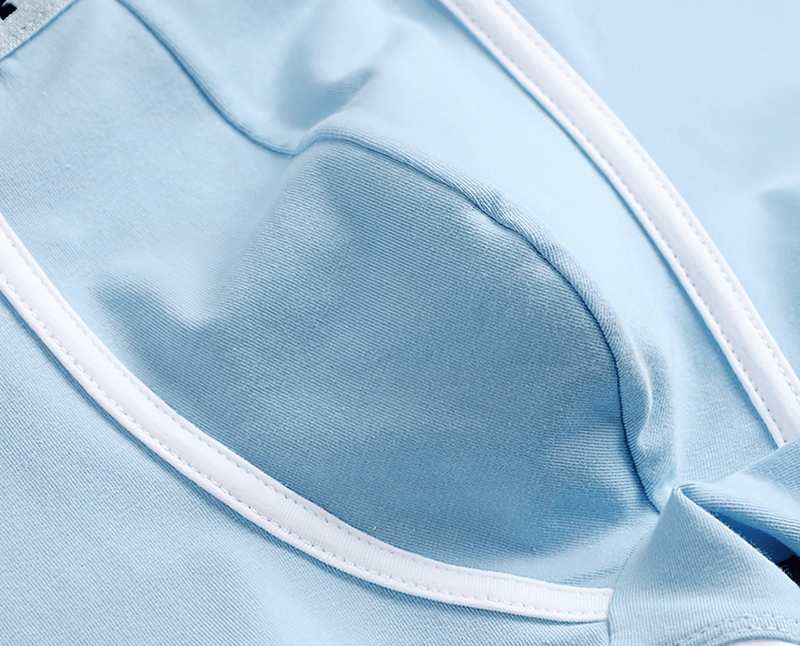 Close-up of light blue men's cotton boxer with white trim, showcasing breathable and comfortable fabric detail.