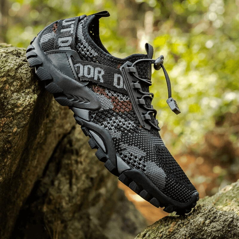 Men's Soft Breathable Non-slip Trekking Sneaker on rocky terrain, featuring a lace-up design with durable rubber outsole for outdoor adventures.