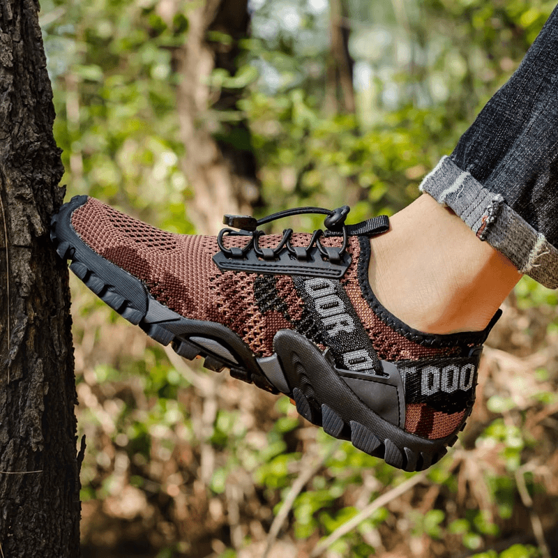 Men's brown breathable non-slip trekking sneakers SF0820 with lace-up closure, shown outdoors.