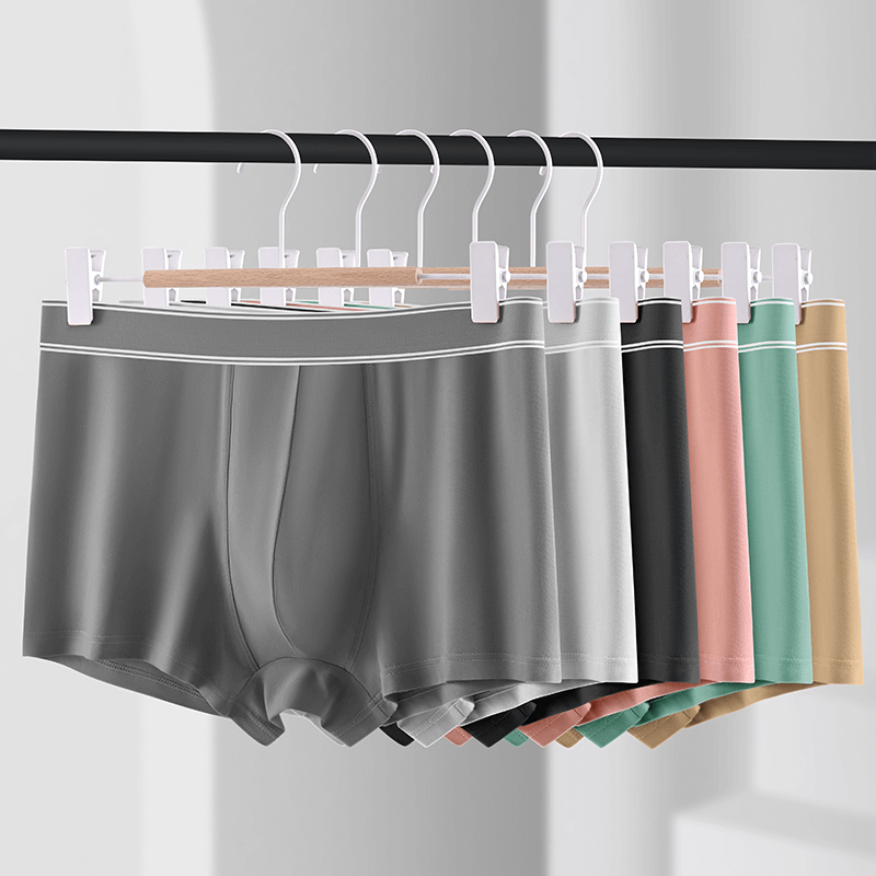 Soft cozy cotton boxers for men in various colors hanging on a rack, showcasing breathable comfort and stylish design.