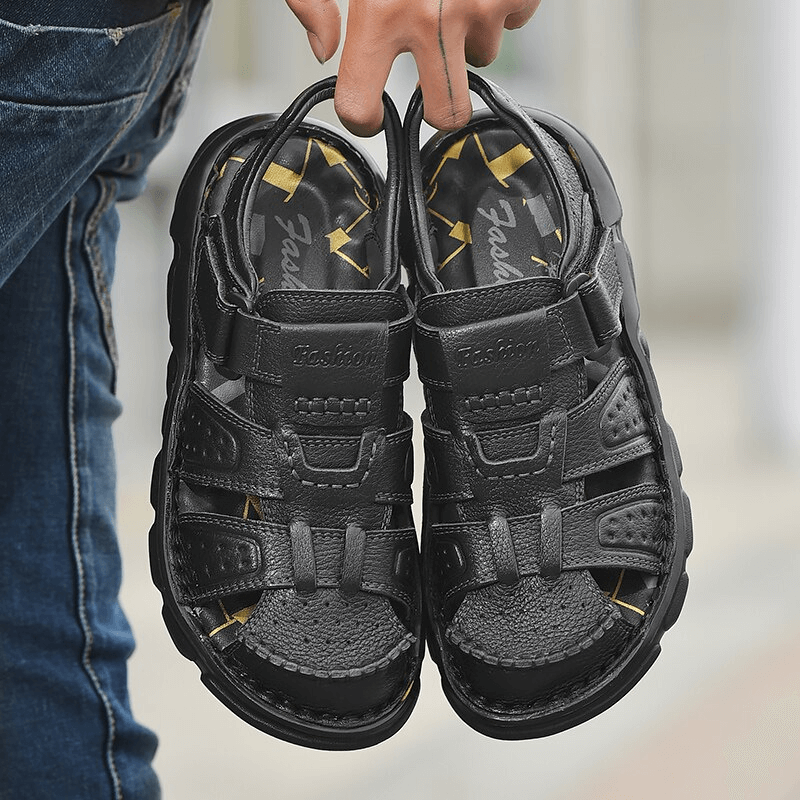 Men's genuine leather trekking sandals with soft soles and anti-collision toes, perfect for hiking. Adjustable fit and rubber outsole.