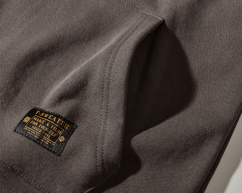 Solid color kangaroo pocket warm round neck sweatshirt in dark brown, featuring a detailed fabric texture and stylish label.