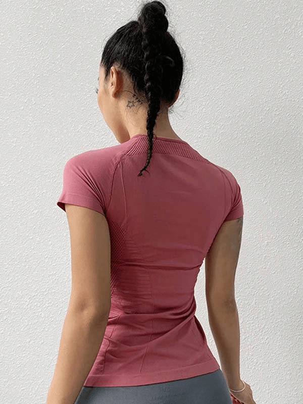 Back view of woman in a solid color quick-drying sports short sleeves t-shirt, perfect for yoga. Breathable and stylish activewear for women.