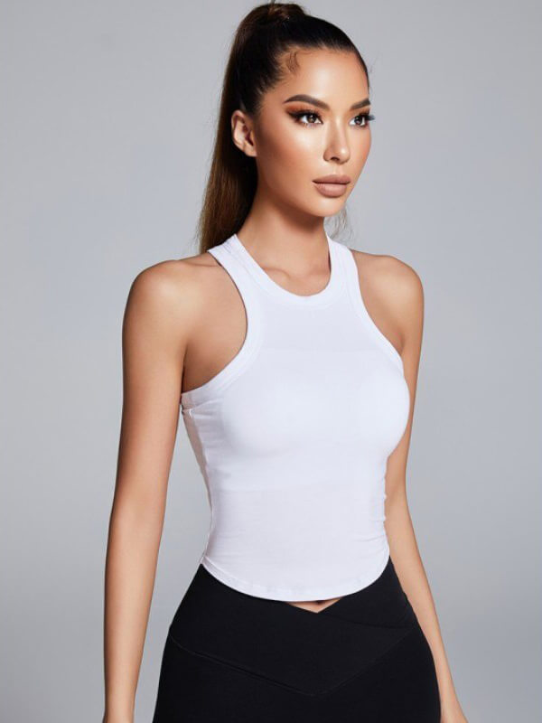 Woman wearing solid high neck white tank top, showcasing breathable nylon fabric and stylish fit. Perfect versatile fashion choice.