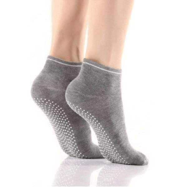 Gray sports anti-slip breathable women's socks with massage granules, worn by a model, showcasing elasticity and snug fit.