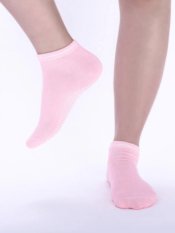 Pink sports anti-slip breathable unisex socks with massage granules for comfort, displayed on foot.