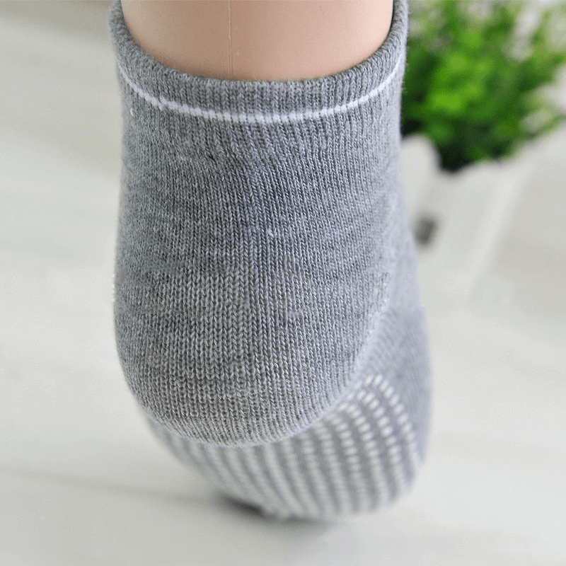Gray sports sock showcasing anti-slip sole and breathable cotton design, perfect for active women.