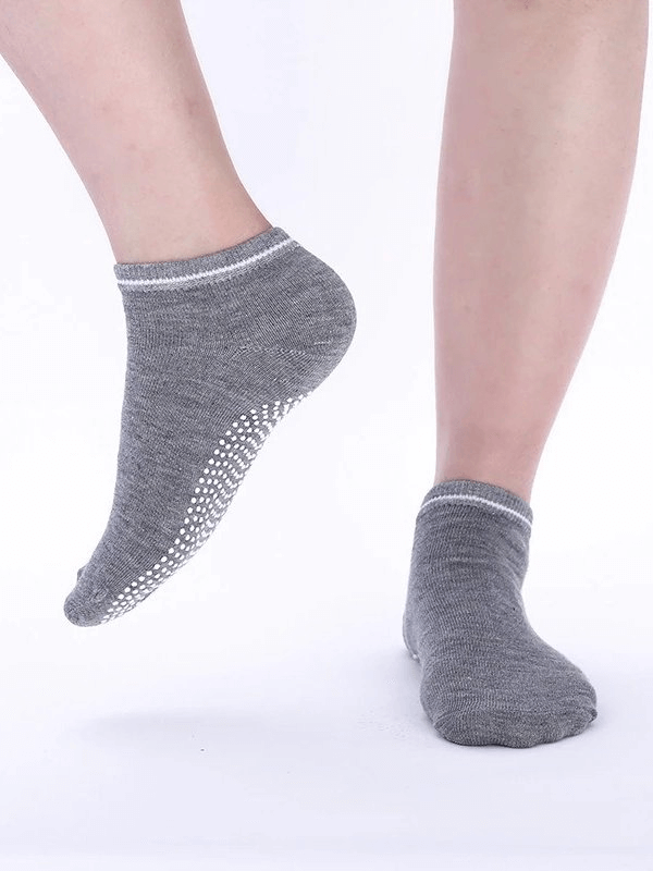 Grey sports anti-slip breathable women's socks with massage granules, shown on feet for a snug fit and comfort.