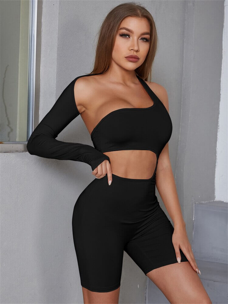 Model wearing a black asymmetrical high-waisted romper, showcasing a sporty and stylish design perfect for streetwear and casual occasions.