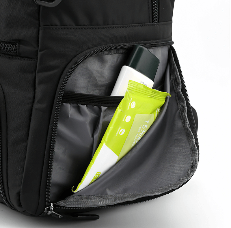 Open side pocket of sports backpack holding a bottle and packet, showcasing storage capacity and convenience.