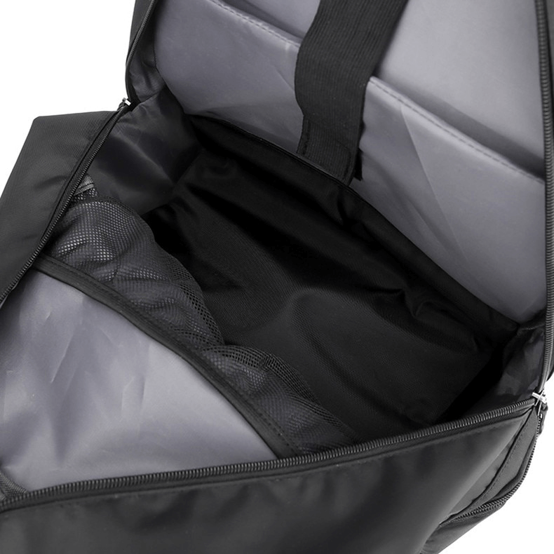 Open view of sports backpack with shoe compartment, featuring a spacious interior and detachable net pocket, in black.