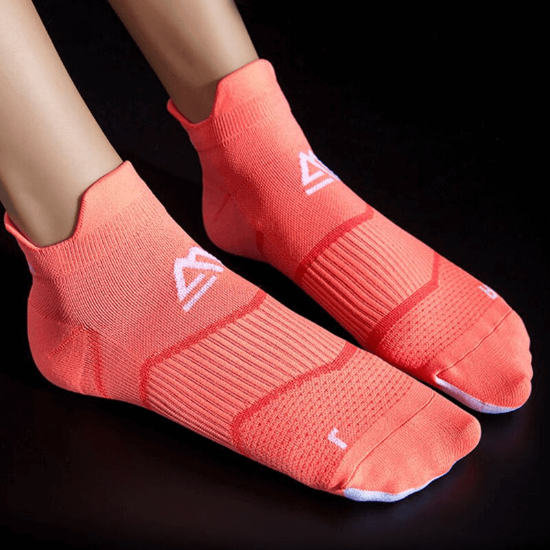Bright coral breathable elastic low-rise sports socks for men and women, featuring ankle support and lightweight cotton material.