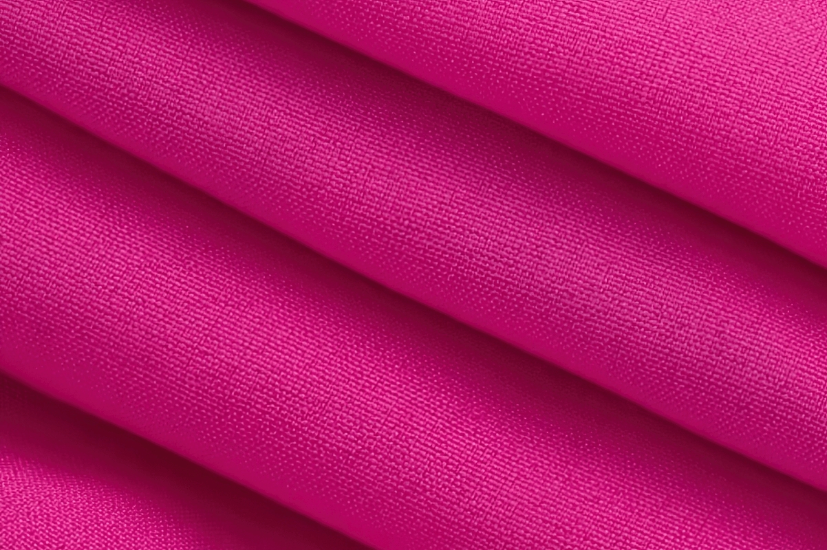 Close-up of vibrant pink breathable polyester fabric used in athletic quick-dry women's hiking pants.