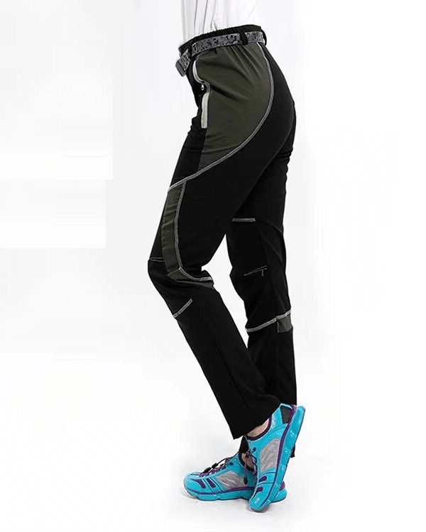 Woman wearing sports breathable quick-drying hiking pants SF0240, black and grey, with blue sneakers. Ideal for outdoor activities.