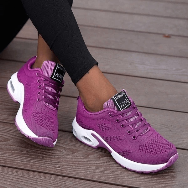 Women's breathable purple running shoes SF0275 with mesh upper and cushioned insole, worn outdoors for comfort and style.
