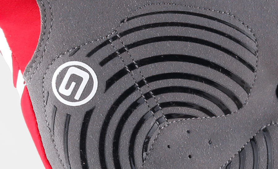 Close-up of black and red unisex half-finger cycling glove with breathable material and grip design for comfort and durability.