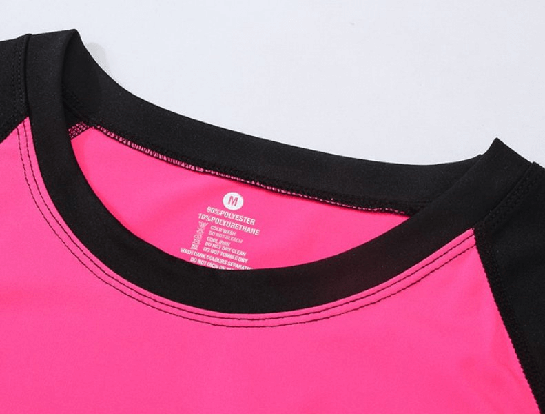 Close-up of pink and black Sports Elastic Women's Short-Sleeve Split Suit showcasing eco-friendly fabric and design details for training.