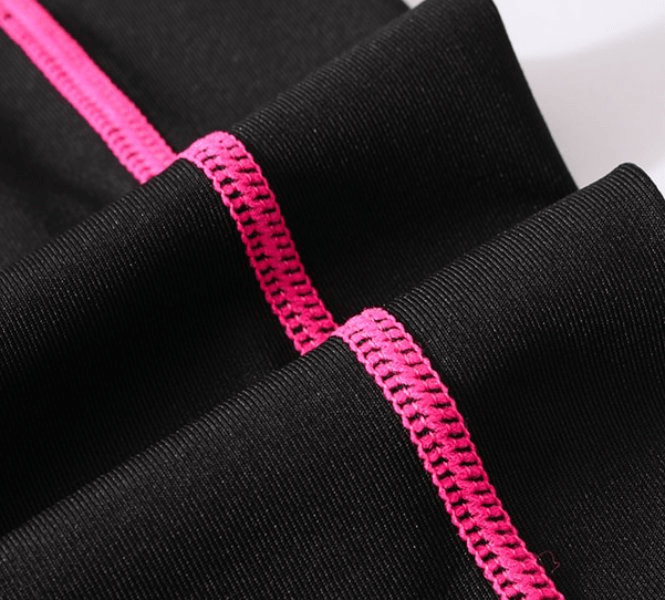 Close-up of black sports fabric with pink stitching detail, showcasing the quality of the Sports Elastic Women's Training Suit.