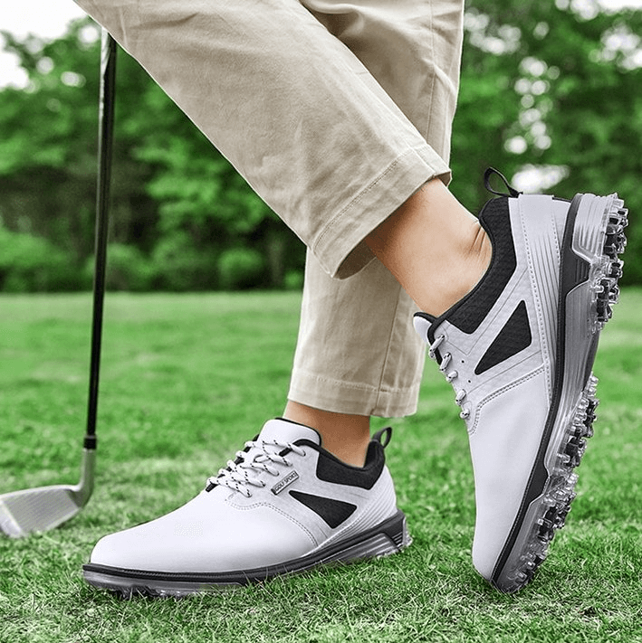 Man wearing sports flexible non-slip men's sneakers golf shoes SF1175 on grass with golf club, showcasing comfort and grip.