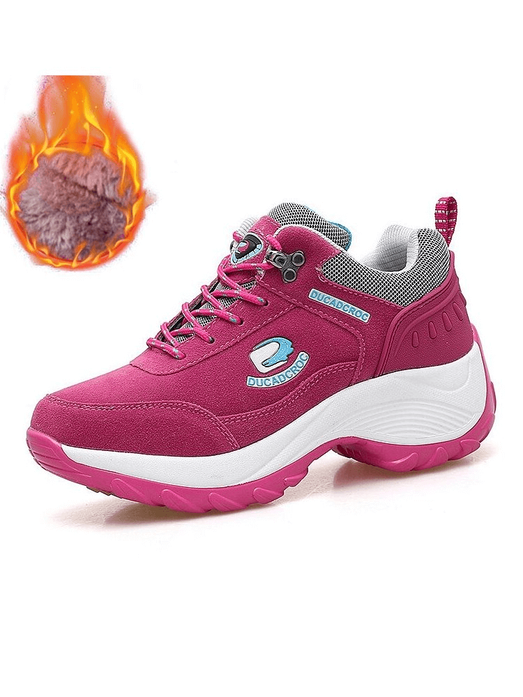 Pink women's sports sneakers with non-slip lace-up closure, faux fur lining, and mid-heel. Insulated design for warmth and comfort.