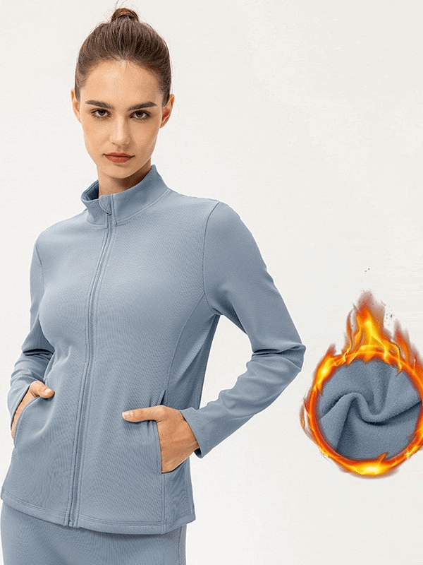 Stylish women's insulated jacket with fleece lining, high collar, and non-slip zipper, perfect for sports. Model wearing sleek blue design.